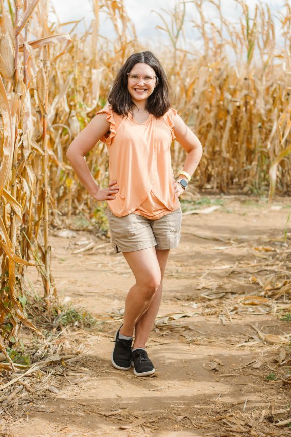 Photo of a woman standing in a corn maze