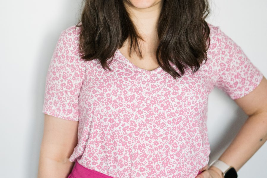 Woman wearing pink floral shirt and bright pink pants