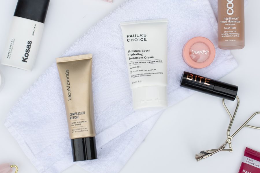 A flat lay photo showing makeup and skincare items on a white background